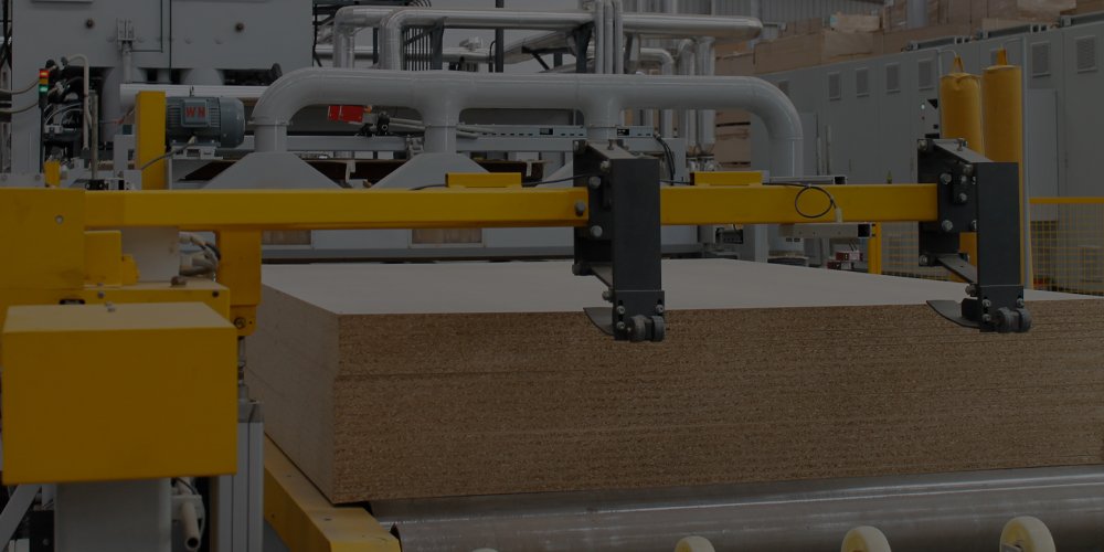 Machine cutting and processing material on factory line