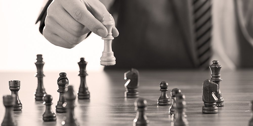 Hand moving chess piece symbolizing strategic decision